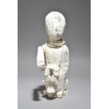 A Ewe power figure Ghana the seated figure with an outstretched right arm and wearing a bead