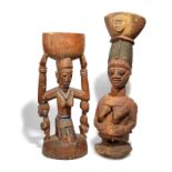 A Yoruba offering female figure Nigeria kneeling with two attendants and supporting a bowl on her