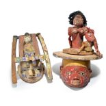 Two Yoruba Gelede masks Nigeria with pigment decoration, one with a figure sitting in a deck