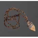 An Aboriginal knife pendant Australia knapped stone with a gum binding the bi-coloured hair