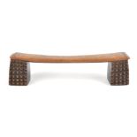 A Zulu neckrest South Africa with amasumpa carved supports and linear decorated ends, 39.5cm long,