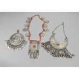 A Yemen necklace silver coloured metal and glass beads, with disc pendants and a rectangular amulet,