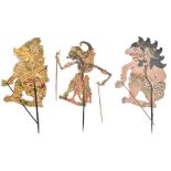 Three Bali puppets Indonesia pierced painted vellum, with horn and wood handles, 82cm, 91cm and 98cm