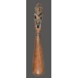 A Papua New Guinea pounder Melanesia with a carved male figural finial, 54cm long.