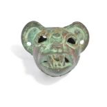 A Chimu jaguar head pendant Peru hollow cast copper with attachment holes to the back, 4cm high.