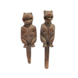 Two Northwest Coast bear pegs possibly Nootka or Kwakiutl seated with oblong outlines to the flat