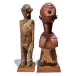 A Lobi standing male figure Burkina Faso with pigment, 56.5cm high, on a fixed base, and a Baga