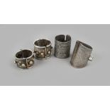 Three Nubian bracelets silver coloured metal, including Libya with engraved decoration of fish and