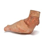 A Moche figural vessel Peru, circa 200 - 500 AD pottery with painted decoration, lying and holding a