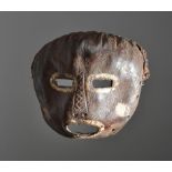 A Mbole mask Democratic Republic of the Congo leather with fibre and cloth, with white pigment