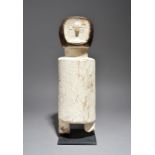 An Akan ancestor figure Ghana with inset cowrie shell eyes and with kaolin, 40cm high, on a