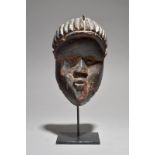 A Bassa mask Liberia 21cm high, on a stand. (2) Provenance UK collection. Owen Hargreaves, London.