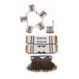 A Ndebele cache-sexe South Africa glass beads, cloth and fibre tassels, 12.5cm long, a pair of