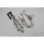 An Ethiopian necklace silver coloured metal, with eleven amulets and with spacers, later strung