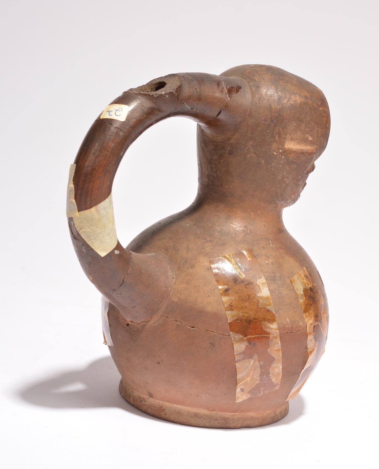 A Moche stirrup vessel Peru, circa 100 - 600 AD pottery with a skull top and with painted cloak - Image 2 of 2
