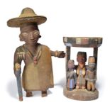 A Yoruba standing figure Nigeria wearing a large rimmed hat and holding a staff, with painted