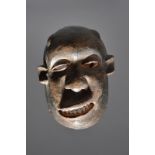 A Makonde sickness mask Mozambique/Tanzania with pigment highlights, 25cm high. Provenance Owen