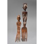 Two Ifugao forks Philippines with standing figure handles, 16.5cm and 24cm long. (2)