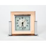 A DEP Savoy desk alarm clock, chrome Odeon style stand supporting peach tinted glass body, with