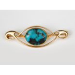 A Murrle Bennett gold and turquoise brooch, looped wirework frame with central turquoise stone,