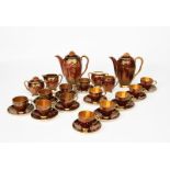 A Carlton Ware Rouge Royale coffee set for six, printed in gilt and enamelled in green with a