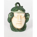 A Czechoslovakian pottery box and cover, modelled as an enigmatic maiden's head with headband and