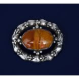 A Georg Jensen silver and agate brooch designed by George Jensen, model no.108, pierced and cast