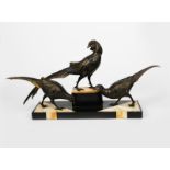 A large patinated spelter sculpture of three exotic birds, on stepped polished onyx and slate