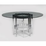 A Merrow Associates chromed metal and glass table, circular glass top resting on chrome metal