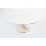An Arkana Tulip table designed by Eero Saarinen, circular, white laminated wood top, on painted