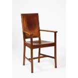 An Arthur Simpson of Kendal walnut armchair, dated 1928, chamfered legs and carved arms, with tan