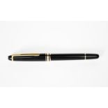 A Mont Blanc Meisterstuck ball pen, black with yellow metal bands and clip, 13.5cm. long
