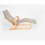 An Isokon Plus bent ply long chair designed by Marcel Breuer, with grey padded cushion, applied