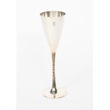 A Stuart Devlin silver gilt champagne flute, model no.500, flaring conical body with textured gilt