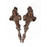 A pair of Art Nouveau carved figures, each modelled as a maiden emerging from a flower stem,