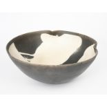 Martin Smith (born 1950) a raku bowl with pinched rim, matt black body resist decorated with white