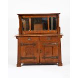 A Liberty and Co style oak buffet sideboard, tapering rectangular section, two drawer base with