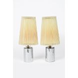 A pair of Adnet style chrome and glass table lamps, the cylindrical chrome base surmounted with a