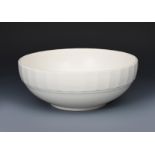 A Wedgwood Moonstone bowl designed by Keith Murray, shallow with faceted rim, covered in a matt