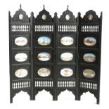 λ AN ANGLO-INDIAN EBONY FOUR-FOLD TABLE SCREEN LATE 19TH / EARLY 20TH CENTURY carved with scrolling