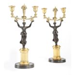 A PAIR OF FRENCH GILT PATINATED BRONZE FIGURAL TWIN-LIGHT CANDLESTICKS EARLY 19TH CENTURY each