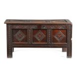 A CHARLES II OAK COFFER LATE 17TH CENTURY the triple panelled hinged top revealing a till, the front