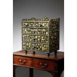 A VICTORIAN EBONISED PINE AND SCRAP-WORK DECORATED TABLE TOP CHEST all over applied with decoupage