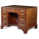 A GEORGE II MAHOGANY KNEEHOLE DESK MID-18TH CENTURY the caddy moulded edge top inset with a later