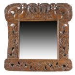 A CARVED BEECHWOOD WALL MIRROR EARLY 18TH CENTURY ELEMENTS the later rectangular plate within a