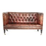 A RED LEATHER SOFA LATE 19TH CENTURY AND LATER with a studded and button upholstered back and seat,