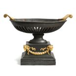 A CAST IRON AND GILT BRONZE MOUNTED BASKET FIRE GRATE REGENCY STYLE of navette shape, with leaf