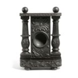 AN ANGLO-INDIAN EBONY WATCHSTAND PROBABLY CEYLONESE, MID-19TH CENTURY carved with scrolling leaves