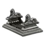 A VICTORIAN BLACK PAINTED CAST IRON BOOT SCRAPER decorated with a pair of recumbent lions and with a