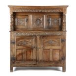 A CHARLES II OAK PRESS CUPBOARD SECOND HALF 17TH CENTURY in two halves, carved with lunettes,